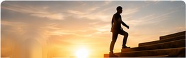 Person climbing steps at sunrise