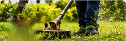 Worker trimming weeds on a lawn